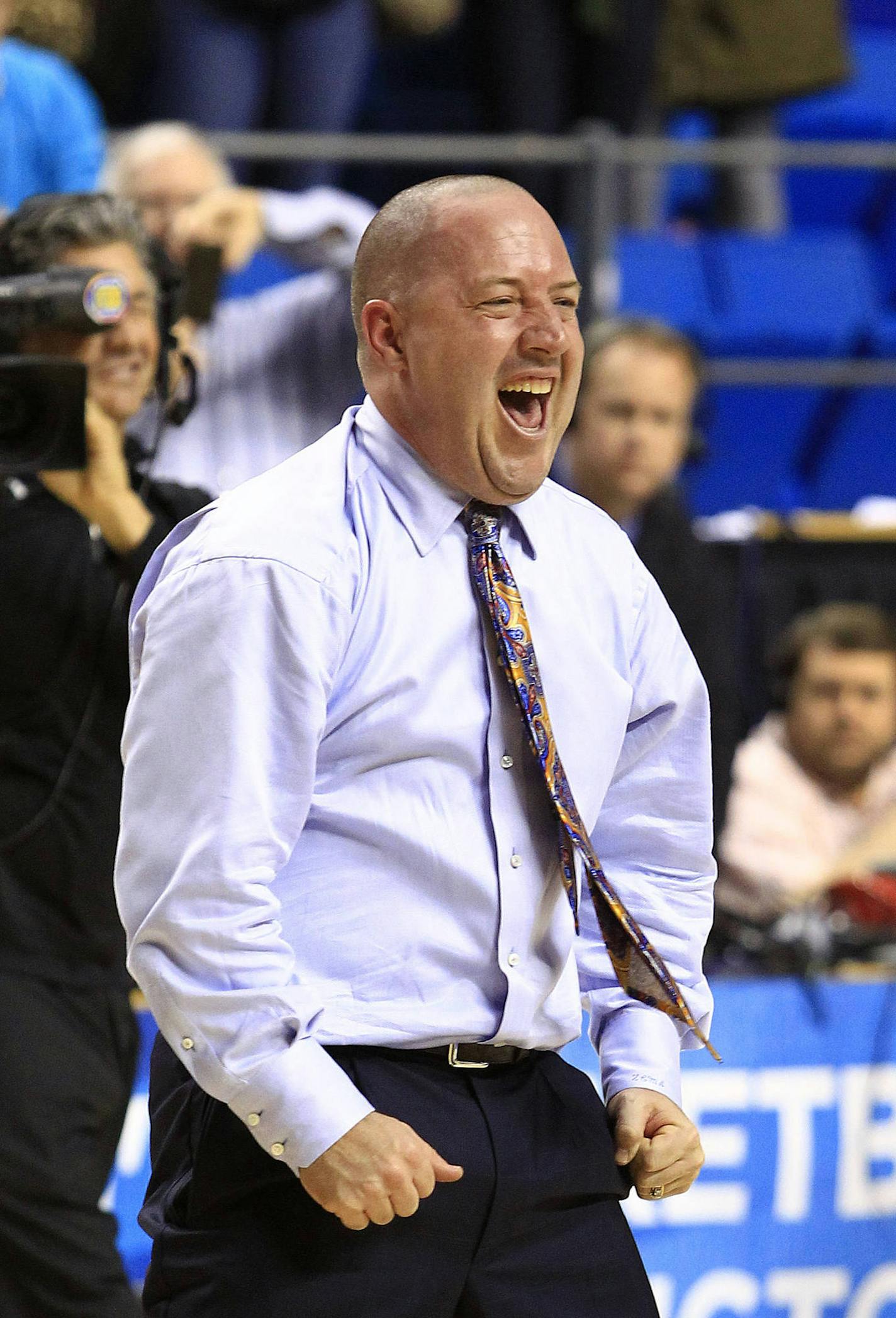 Marquette head coach Buzz Williams celebrates after defeating Butler 74-72 in a third-round NCAA college basketball tournament game Saturday, March 23, 2013, in Lexington, Ky. (AP Photo/James Crisp)