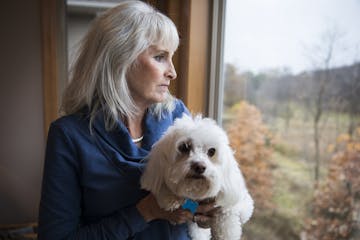 Dawn Swanson at home with her dog CJ, who also has seizures, in Plymouth.