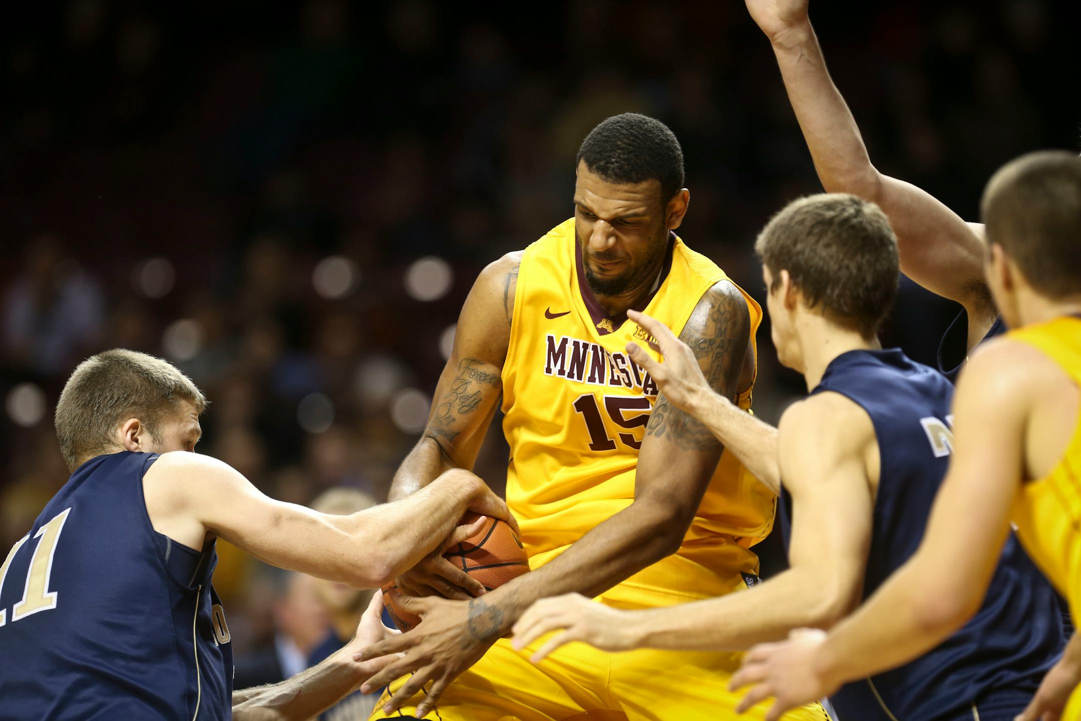 The Gophers' Mo Walker, center, fought for the ball will Concordia's Cole Olstad during the first half on Monday night at Williams Arena.