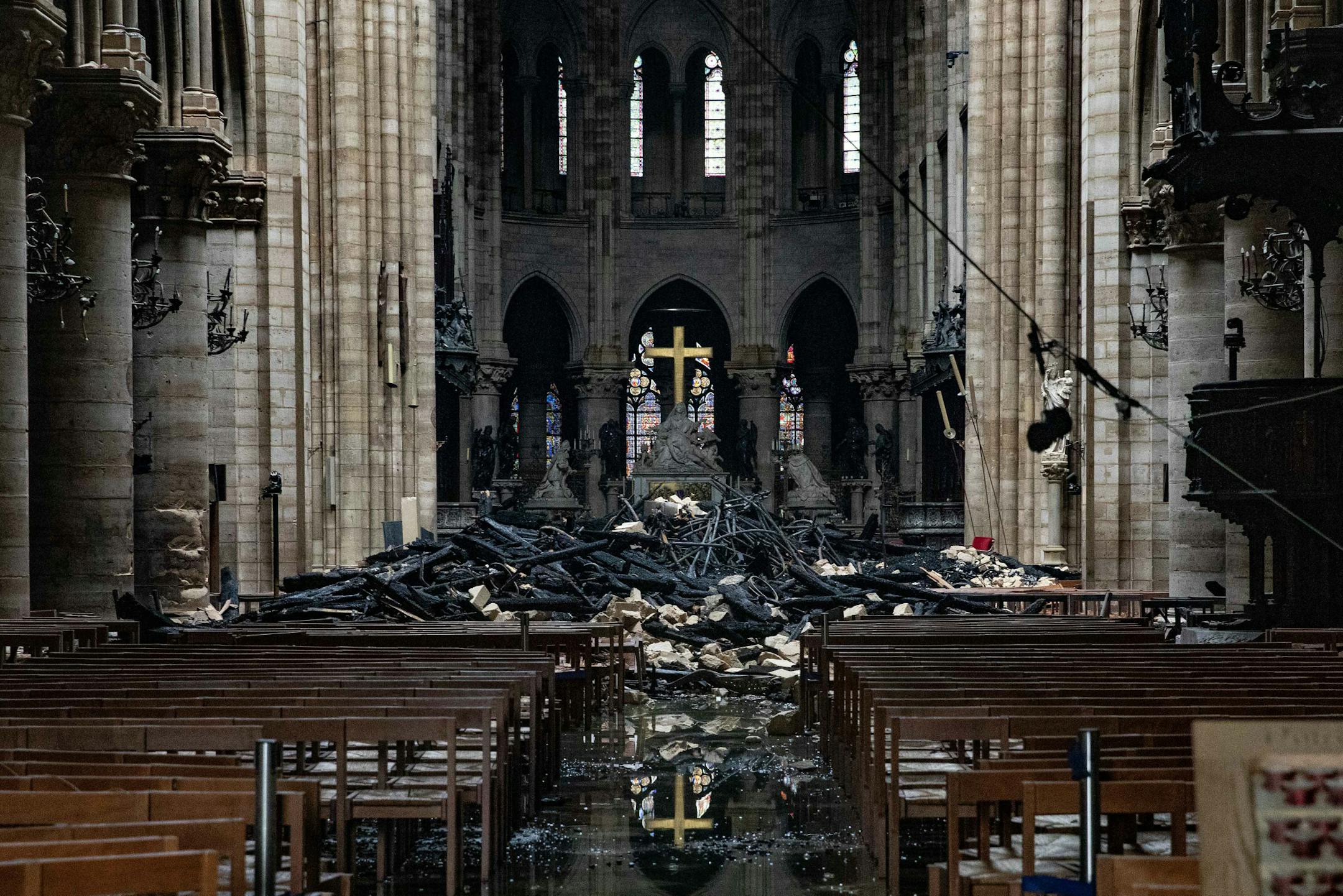 Fire damaged wood and stone sits near the altar inside Notre Dame Cathedral in Paris on April 16, 2019. MUST CREDIT: Bloomberg photo by Christophe Morin.