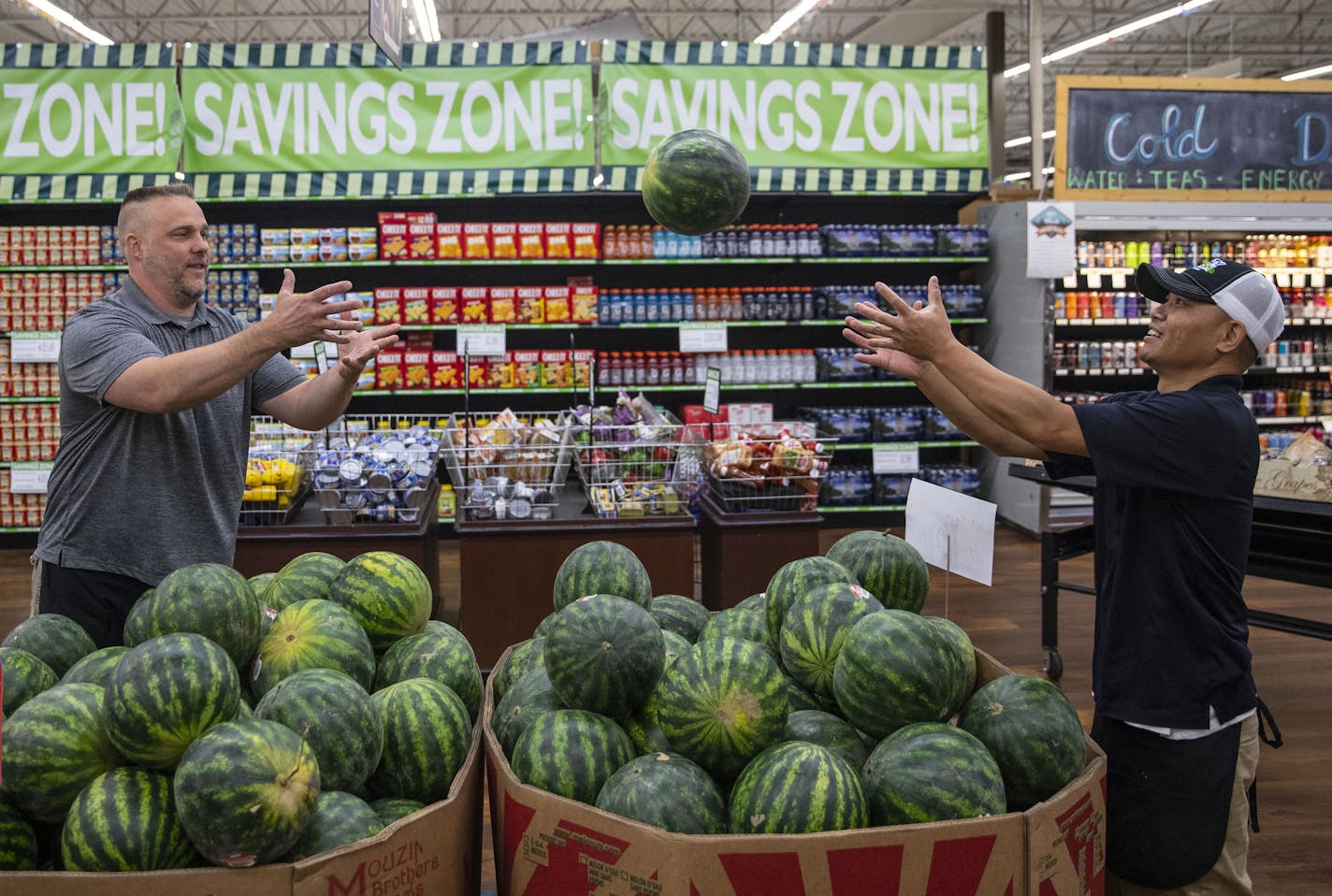 (Left) Produce Manager Jon Maunu tosses a watermelon to his employee, Bob Keomany, as they arrange and put out fresh produce on Tuesday morning.]
ALEX KORMANN &#x2022; alex.kormann@startribune.com Warroad, MN is Minnesota's north-most town, about five miles from the Canadian border. Recently it has seen some economic hardships but those have been continuously met with community members working hard to create innovative ways to rejuvenate the economy and bring in more tourists. A snapshot of busi