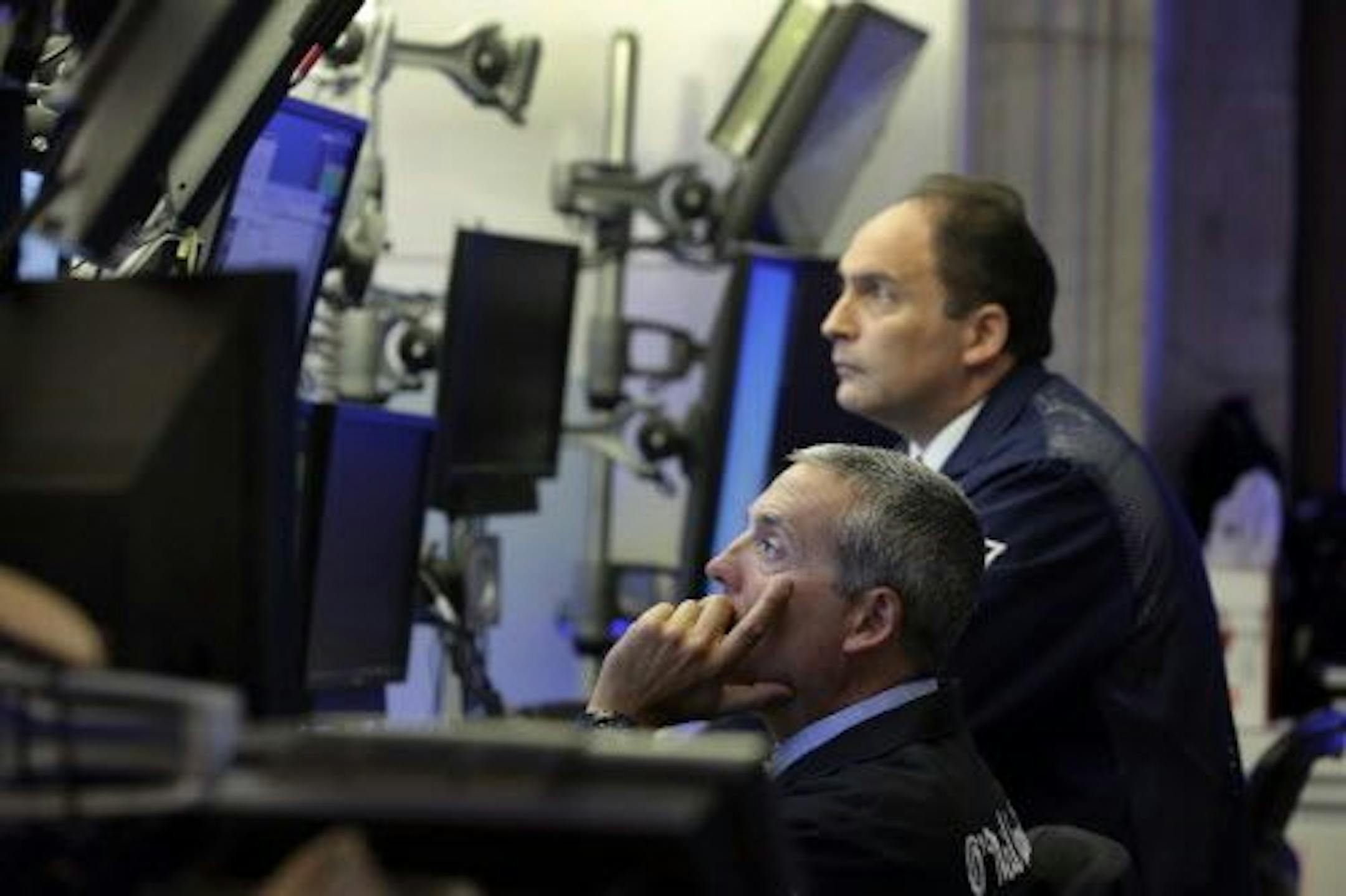 A pair of traders work in their booth on the floor of the New York Stock Exchange, Monday, Aug. 24, 2015. World stock markets plunged on Monday after China's main index sank 8.5 percent, its biggest drop since the early days of the global financial crisis, amid deepening fears over the health of the world's second-largest economy.