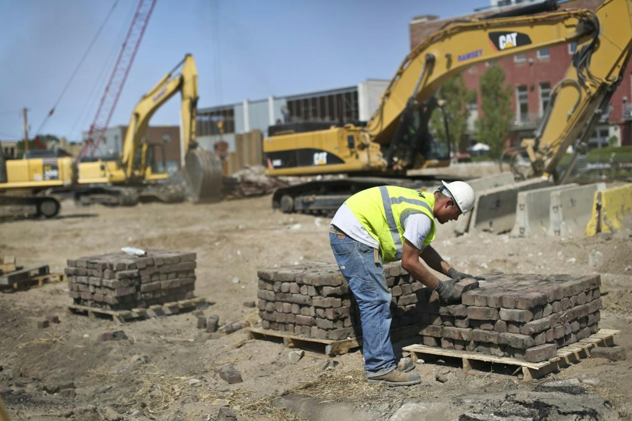 A worker hauled bricks at an apartment building construction site at 800 N. 3rd St. in Minneapolis, Minn., on Friday, August 31, 2012.