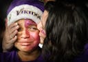 Eli Solano, 12, of St. Cloud, is comforted by his mother, Tiffany Solano, after the Vikings 31-24 loss during a NFL wild card playoff game between the