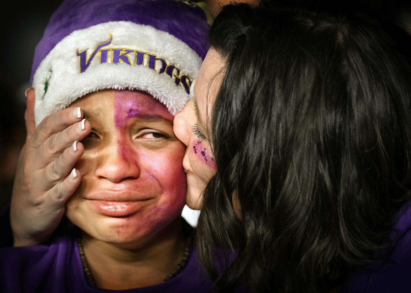 Eli Solano, 12, of St. Cloud, is comforted by his mother, Tiffany Solano, after the Vikings 31-24 loss during a NFL wild card playoff game between the Minnesota Vikings and the New York Giants on Sunday, Jan.15.2023 at U.S. Bank Stadium in Minneapolis.