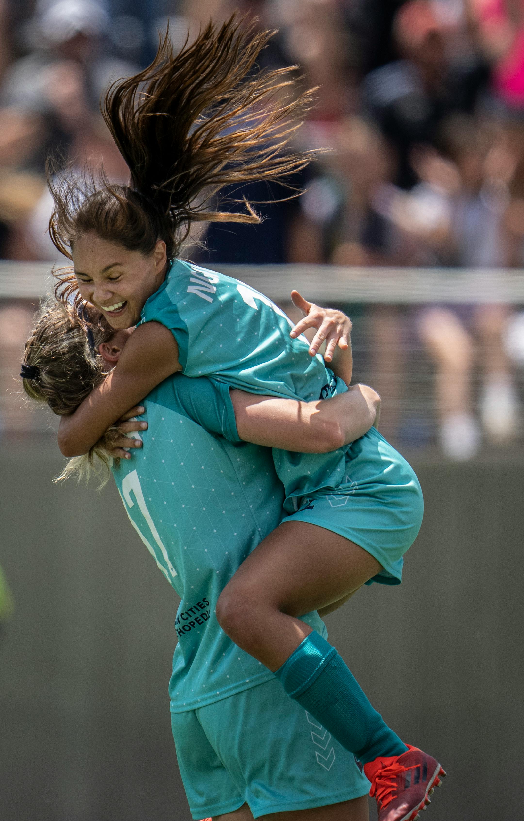 Mariah Nguyen, right, celebrates her first half goal with Morgan Turner.