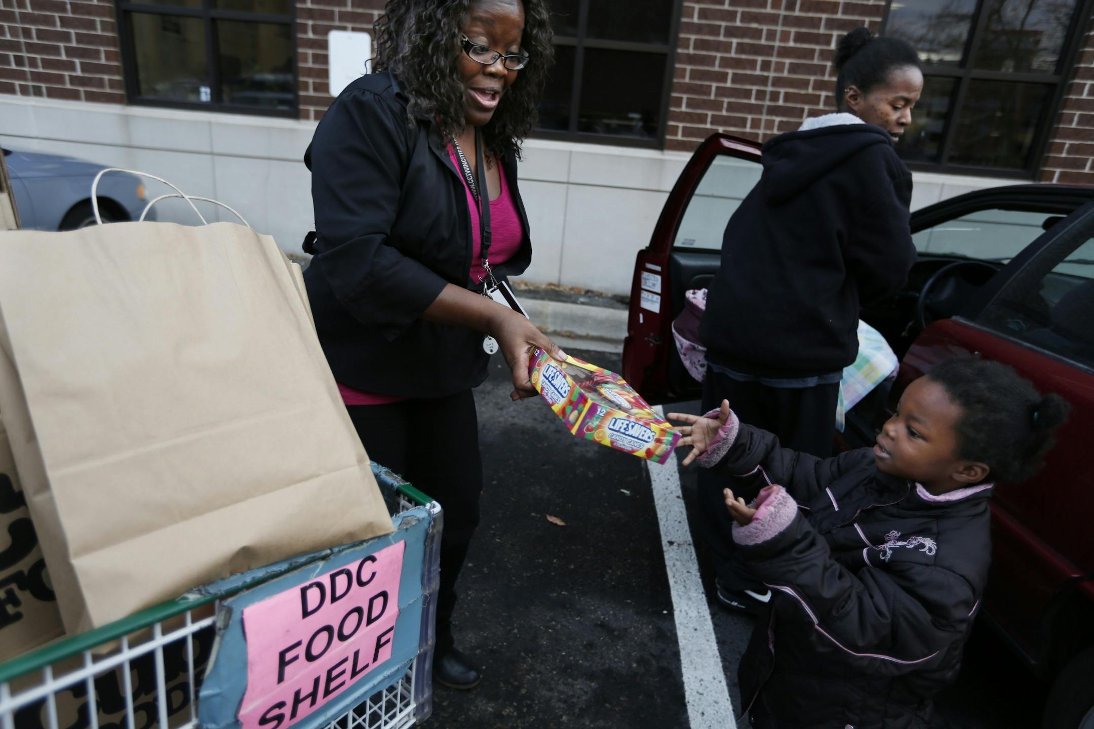 As Congress wrangles with plans to avoid the so-called fiscal cliff, the charitable tax deduction is being scrutinized more closely than ever in its 100 year history. Minnesota charities are on high alert. At the Dorothy Day Center run by Catholic Charities in St. Paul, food support specialist Rukeema Jackson packed some 100 lbs. of food for Robin Scott's family which includes Maziah,4, who was eager to grab a box of Lifesavers candy canes.