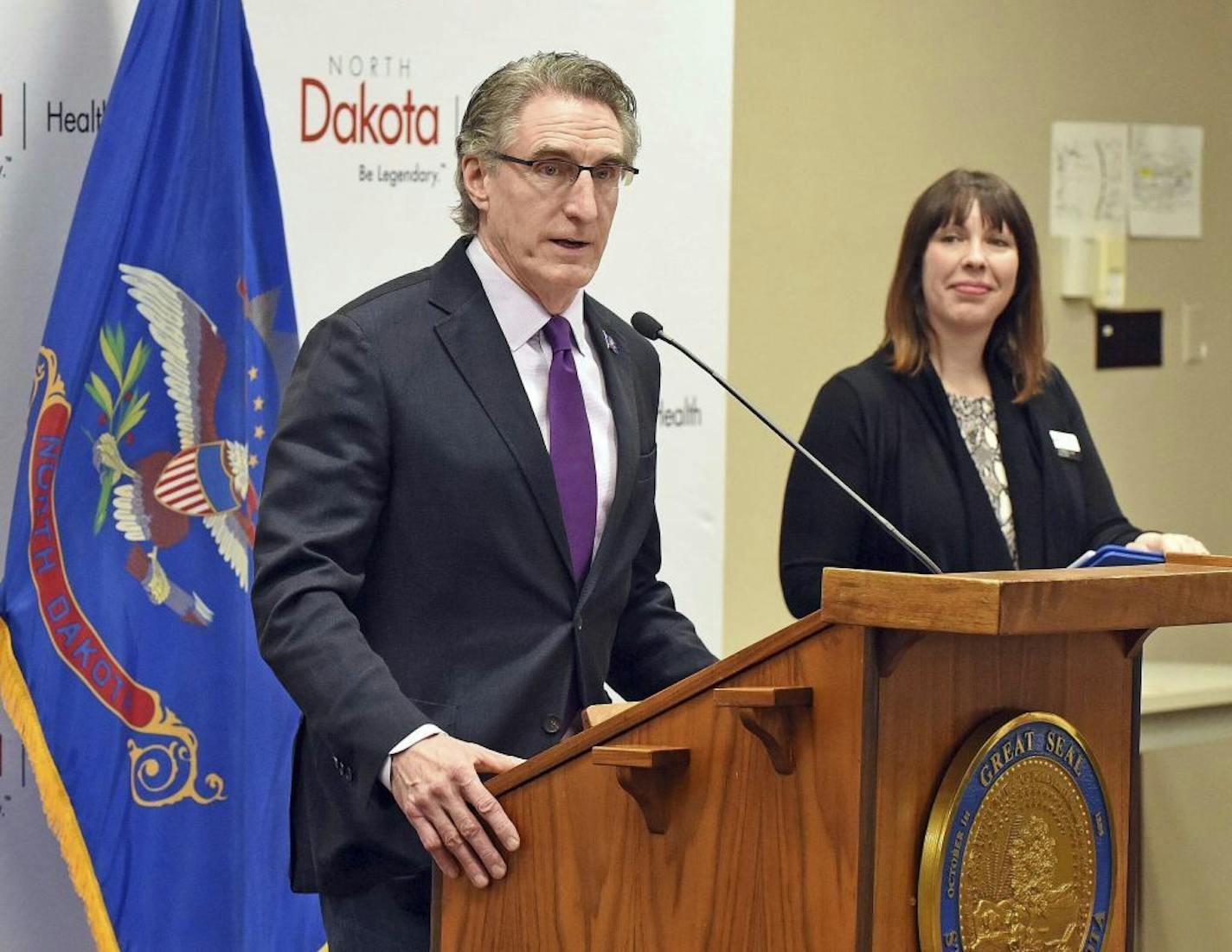 North Dakota Gov. Doug Burgum speakson the growing number of COVID-19 cases during a press conference, Friday, March 20, 2020 in Bismarck, N.D.. Gov. Burgum announced seven new coronavirus cases Friday, increasing the state's total to 26. At right is Molly Howell, Immunization Program Manager for the North Dakota Department of Health.