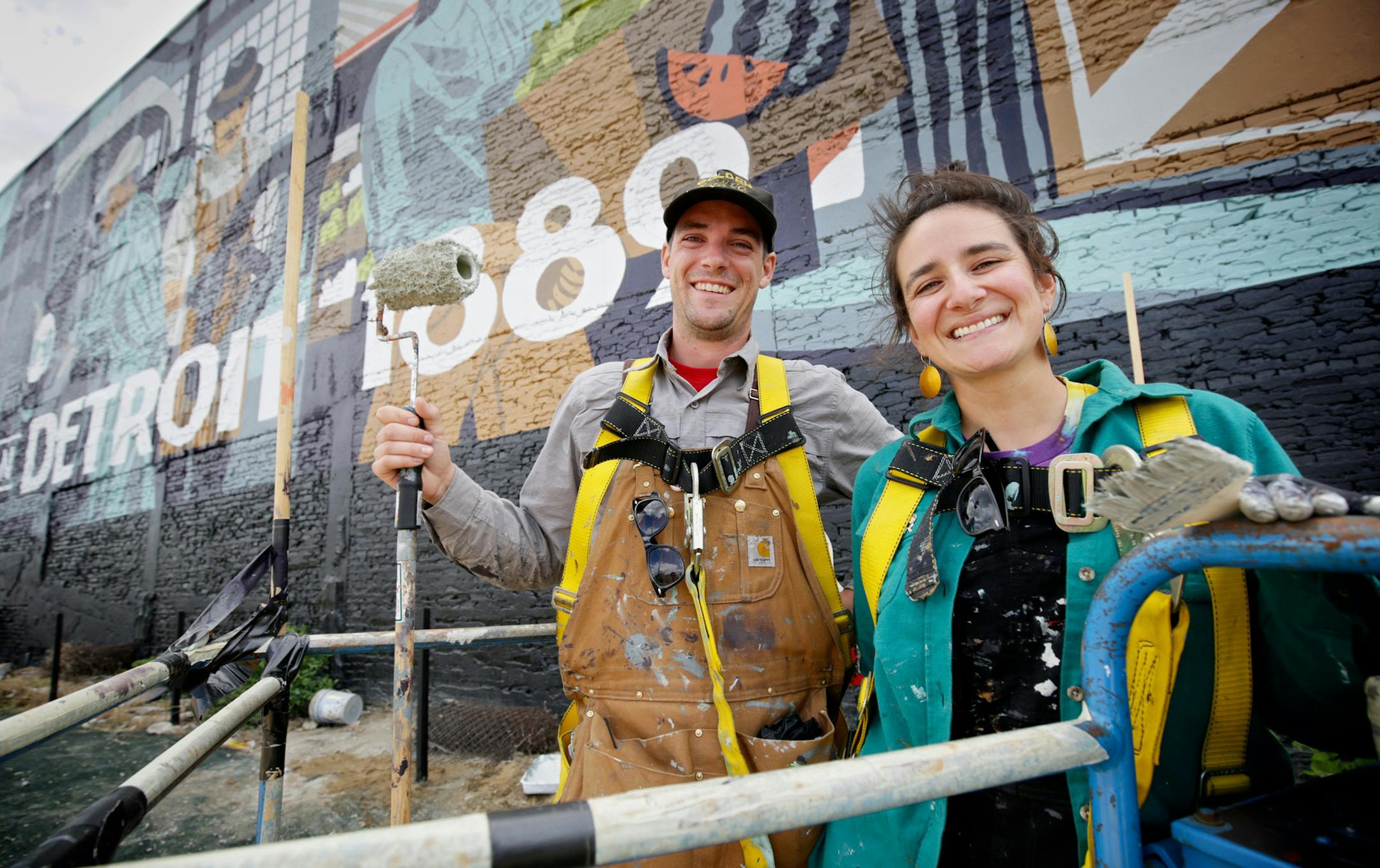 Kelly Golden, 28, and Jordan Zielke, 28, both of New Baltimore, Mich., pose for a portrait during their break as they work on a new mural on Aug. 24, 2015, on the wall of the new Carhartt store in Detroit. The mural was illustrated by James Noellert and Michael Eugene Burdick. (Salwan Georges/Detroit Free Press/TNS) ORG XMIT: 1179288