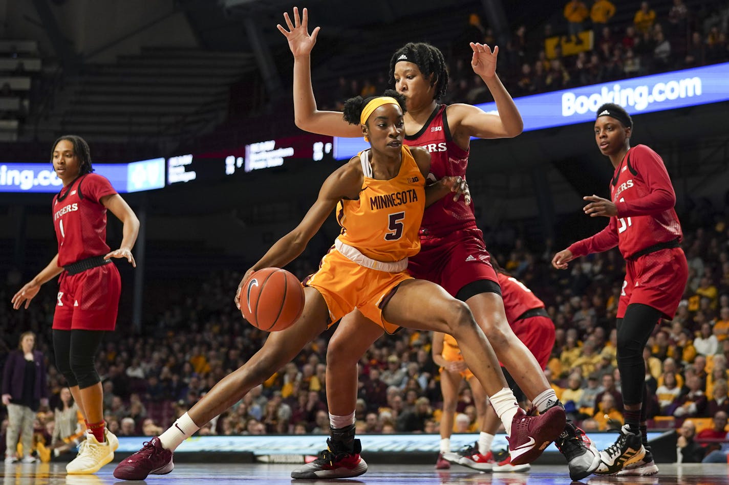 Gophers forward Taiye Bello drove into Rutgers center Maori Davenport in the first quarter. Bello had 19 points and 22 rebounds in Minnesota's 73-71 double-overtime victory at Williams Arena on Sunday. She went only 2-for-8 from the field but made up for it by sinking 15 of 19 free throws.