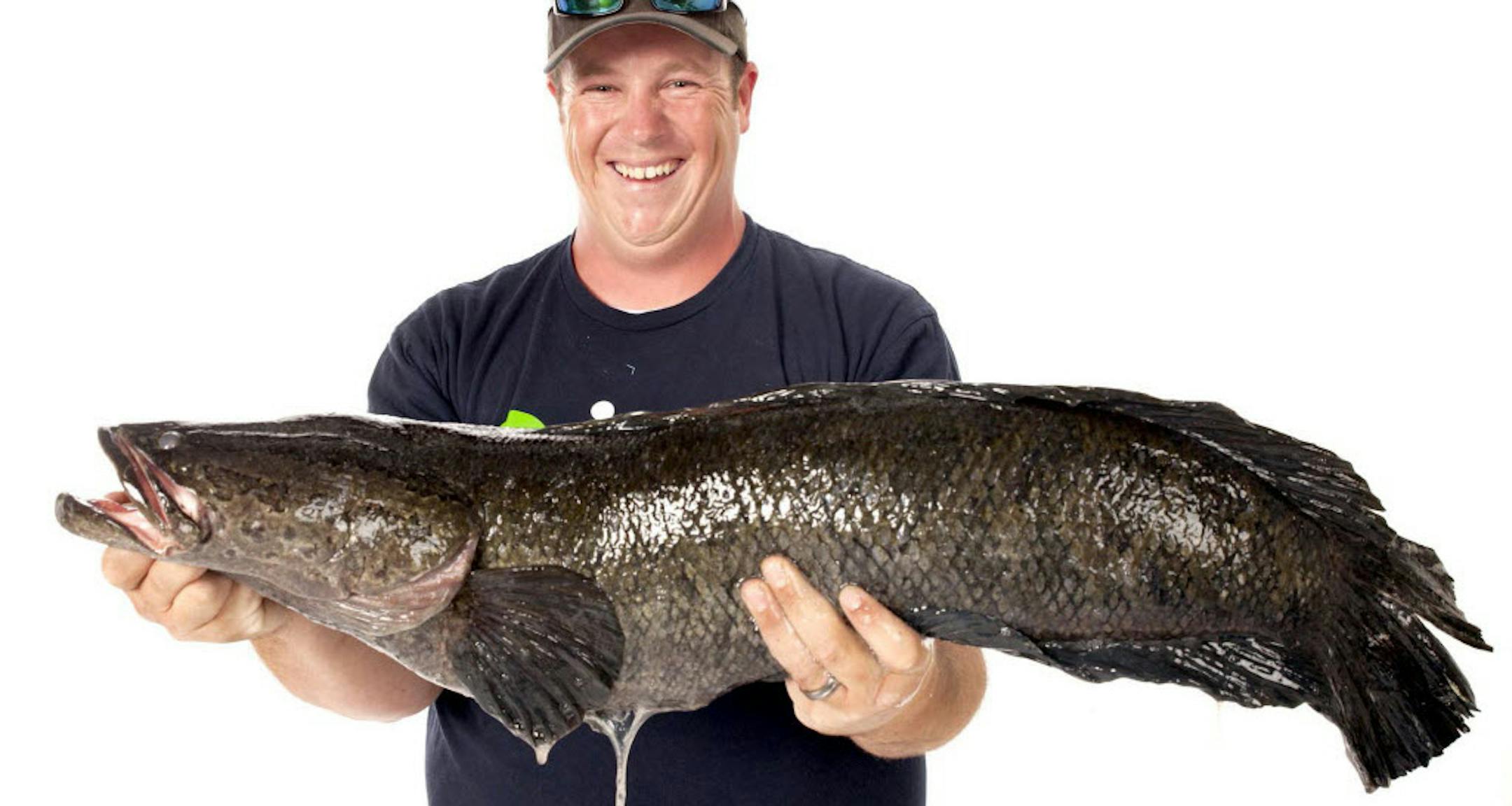 Caleb Newton, who lives in Spotsylvania County, Va., poses June 3, 2013 with the 17 pound 6 ounce northern snakehead fish that he caught in Aquia Creek.