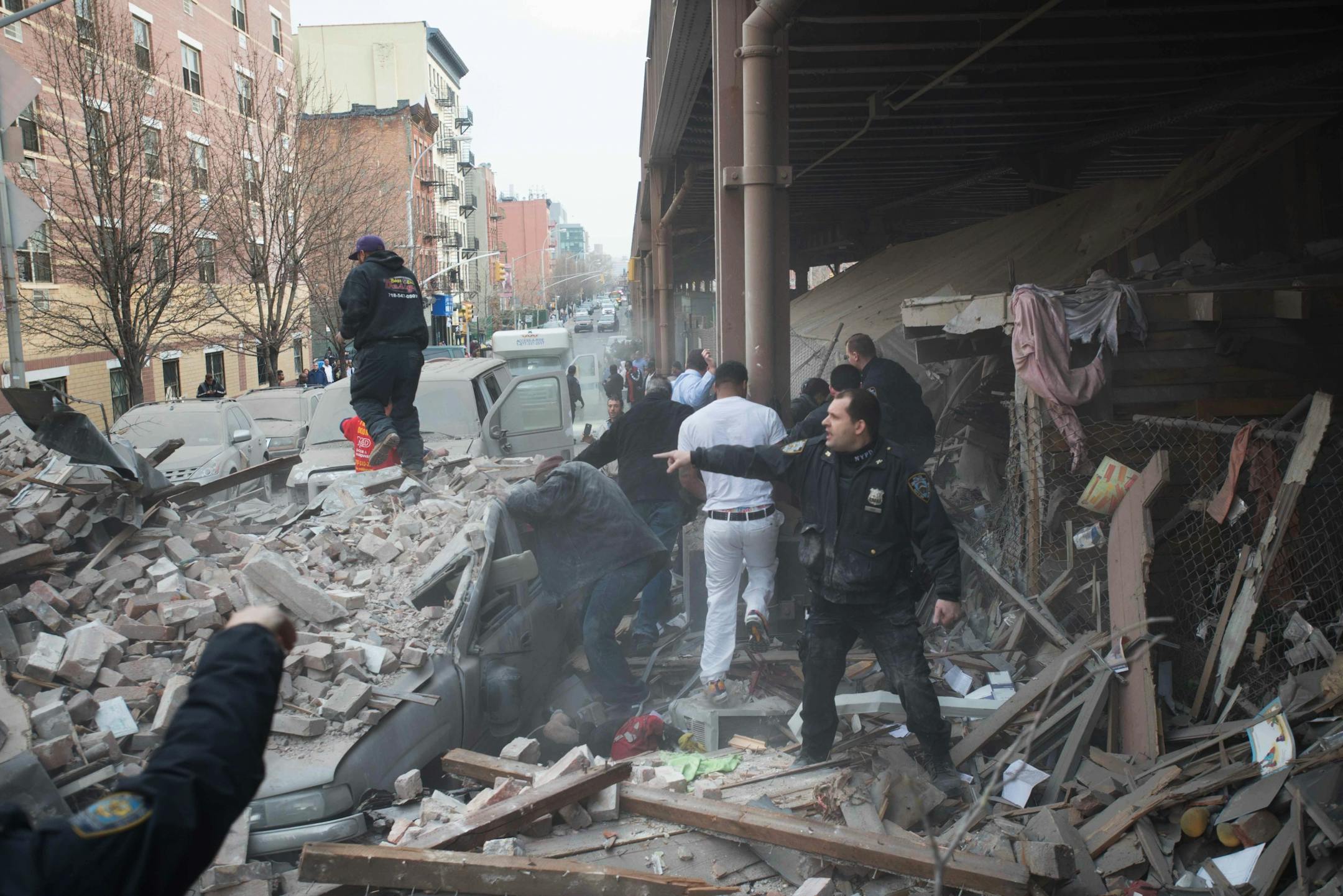 Police respond to the scene of an explosion and building collapse in the East Harlem neighborhood of New York, Wednesday, March 12, 2014. The explosion leveled an apartment building, and sent flames and billowing black smoke above the skyline.