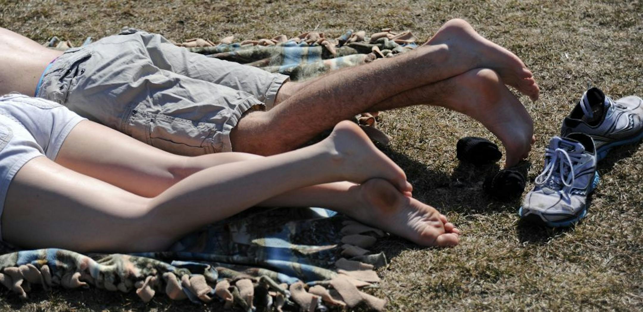 With temperatures possibilly reaching 70's today it was a good day to to out in the sunshine. Andy Dodds and Joanna Lemmage of Apple Valley, Minn are both U of M students who are on spring break. They came to the Lake Harriet bandshell for a picnic in the sun.