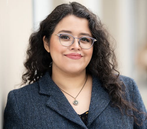photo of author Silvia Moreno-Garca in a grey tweed suit