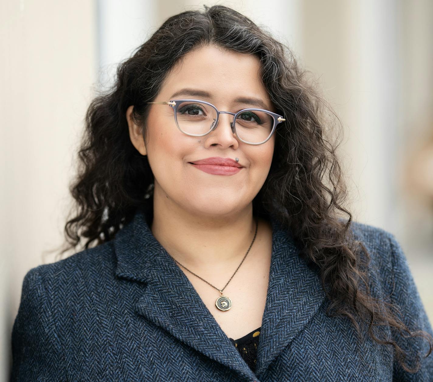photo of author Silvia Moreno-Garca in a grey tweed suit