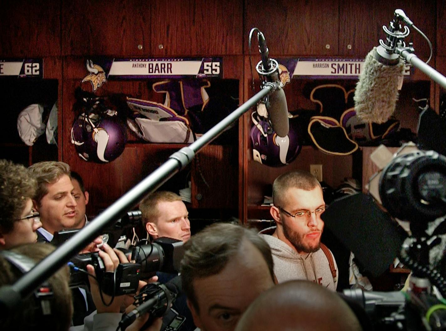 Media invaded the Vikings locker room Monday, with Harrison Smith (right) a target, after Adrian Peterson was indicted on child abuse charges in Texas.