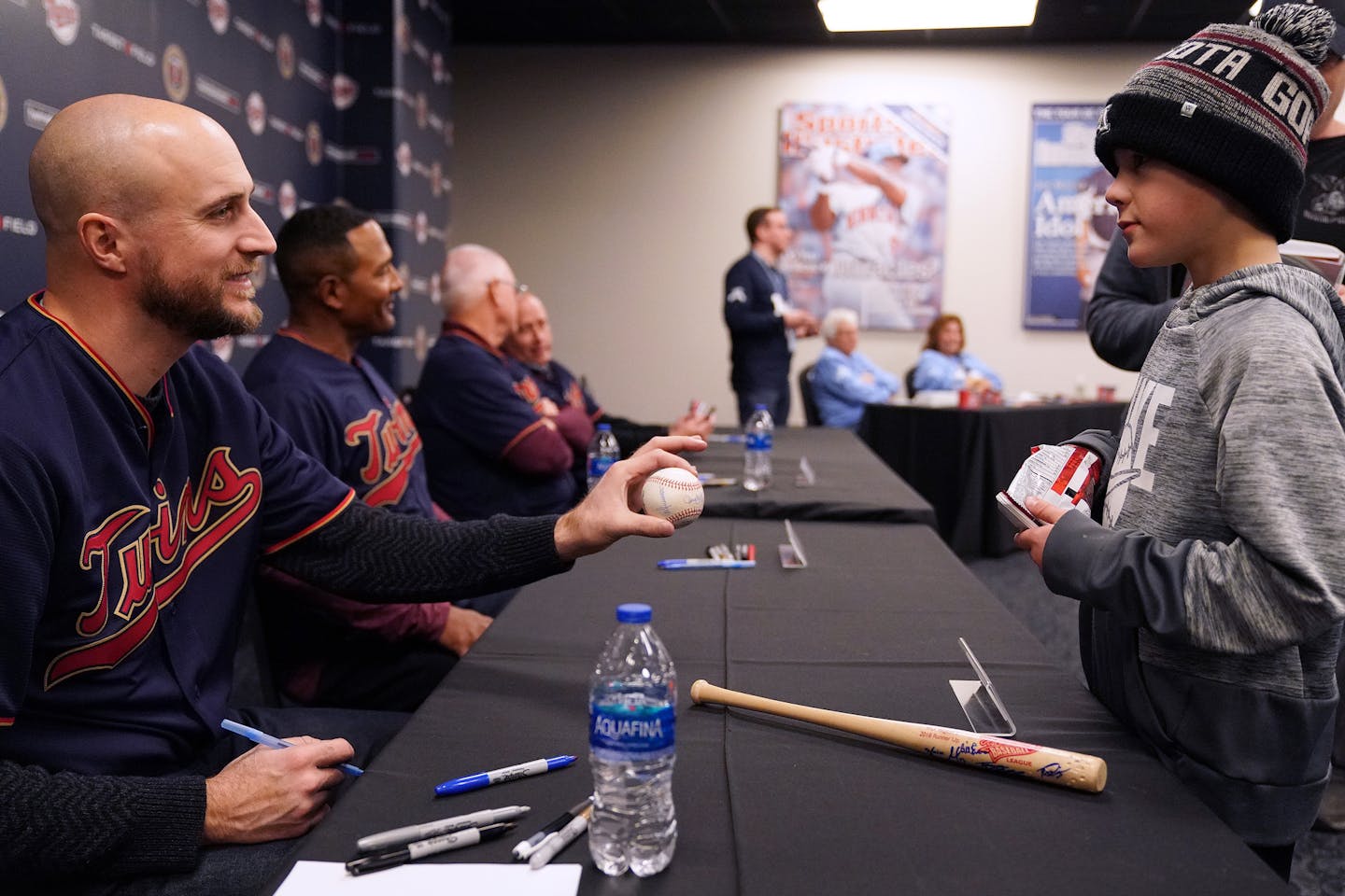 Twin's new manager Rocco Baldelli signed an autograph for Brooks Geiger, 9, as he sat with his fellow coaches during an autograph session.