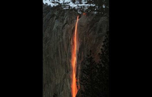 In this Feb. 16, 2010, file photo, a shaft of sunlight creates a glow near Horsetail Fall, in Yosemite National Park, Calif.