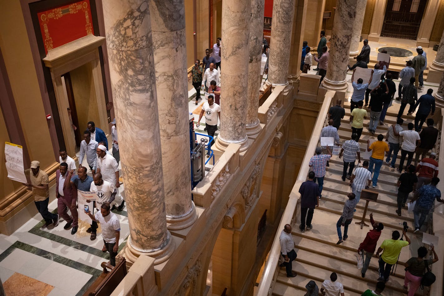 Members of the Minnesota Uber Lyft Drivers Association chanted as they paraded through the halls of the State Capitol Monday night calling on Gov. Tim Walz to sign the bill that gives them a minimum wage and other benefits. The Minnesota Legislature scrambled to complete their work before their midnight deadline for adjourning Monday, May 22, 2023 at the State Capitol in St. Paul. ] JEFF WHEELER • jeff.wheeler@startribune.com