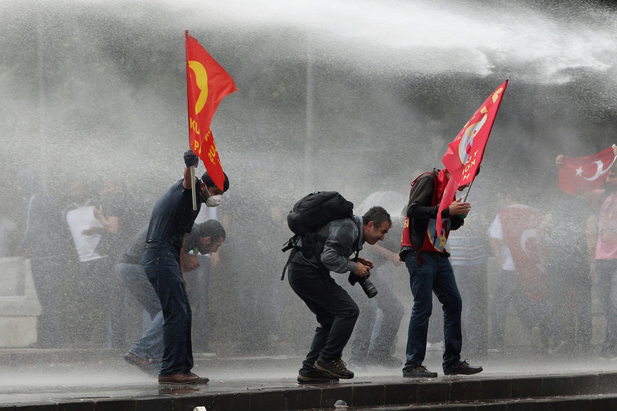 Turkish riot police spray water cannon at demonstrators who remained defiant after authorities evicted activists from an Istanbul park, making clear they are taking a hardline against attempts to rekindle protests that have shaken the country, in city's main Kizilay Square in Ankara, Turkey, Sunday, June 16, 2013.(AP Photo/Burhan Ozbilici) ORG XMIT: MIN2013061609391011