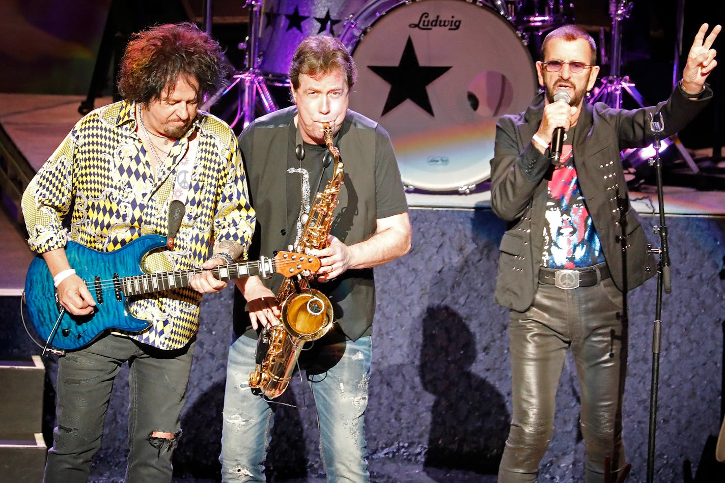 Ringo Starr performs with All Starr Band members Steve Lukather, left, and saxophonist Warren Ham at the Ordway Music Theater Sunday night.