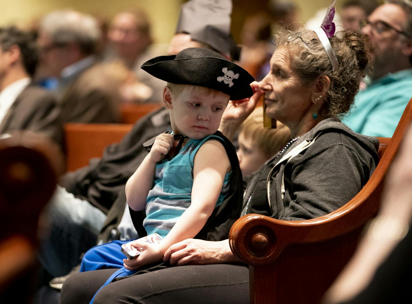 Kalman Ouray, 3, sat on his grandmother Ester Ouray's lap during a service celebrating the festival of Purim at Temple Israel in Minneapolis, Minn., on Wednesday, March 20, 2019. ] RENEE JONES SCHNEIDER &#xa5; renee.jones@startribune.com