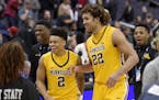 Minnesota center Reggie Lynch (22) and guard Nate Mason (2) react as they leave the court after an NCAA college basketball game against Michigan State