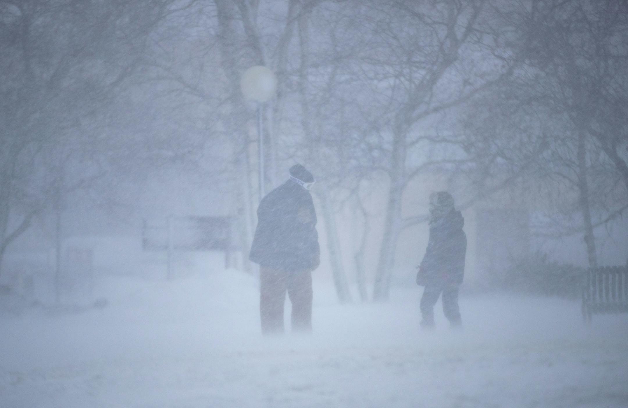 Two people pushed through the snow and wind in Canal Park in Duluth, MN to check out the waves and severe flooding during the snow storm on Saturday November 30, 2019.