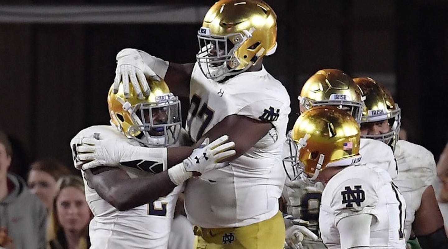 Notre Dame running back Dexter Williams, left, celebrates his touchdown with Micah Dew-Treadway, center, and quarterback Ian Book during the second half of an NCAA college football game against Southern California