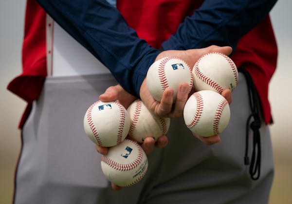 A coach held a brace of balls during drills for pitchers at Hammond Stadium in Fort Myers, Fla., on Tuesday.