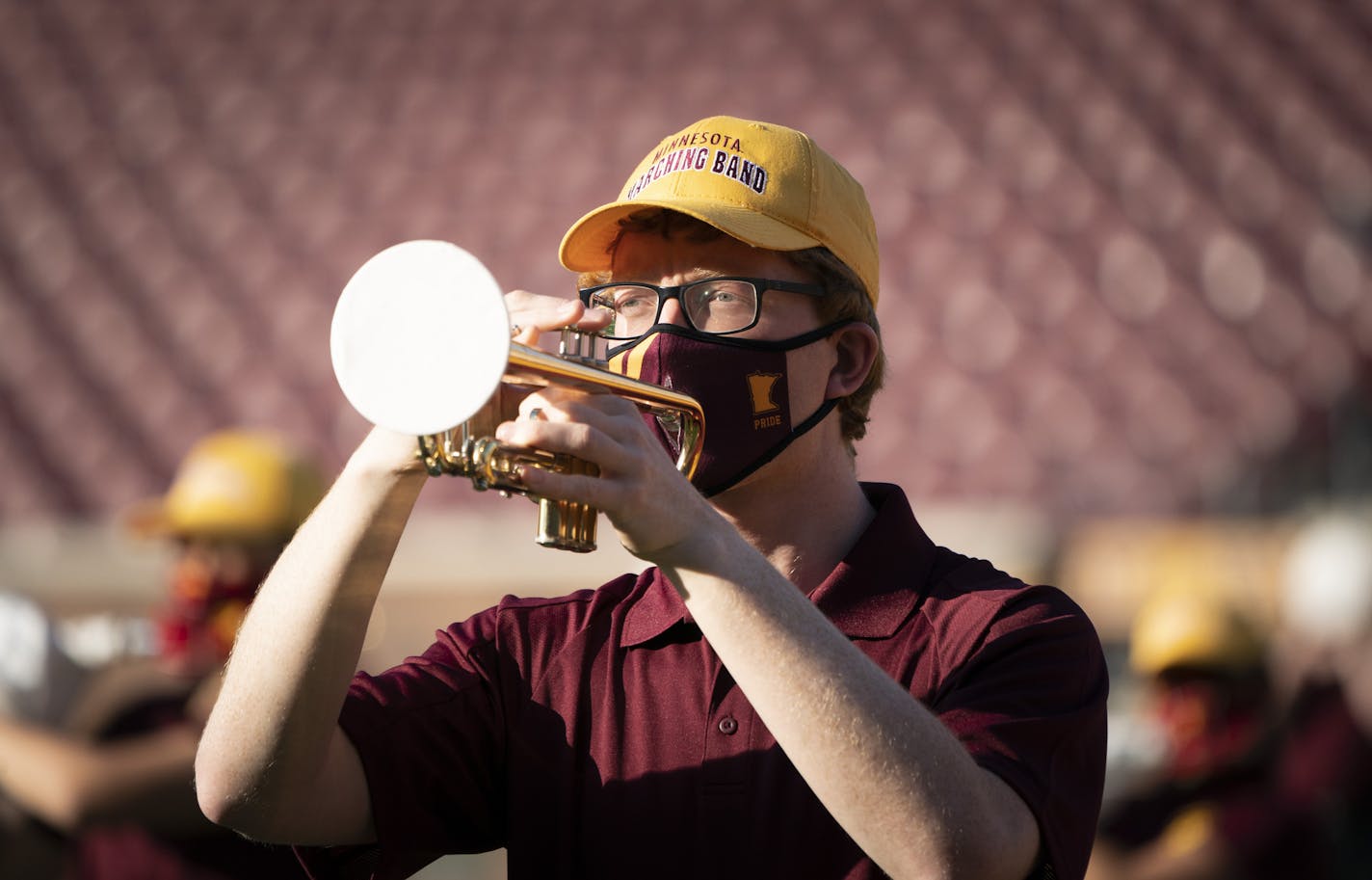 The University of Minnesota marching band wore masks with little holes for the mouth pieces of their instruments along with covers to prevent fine spray as they practiced and recorded their performances to be used at a later game at TCF Bank Stadium in Minneapolis, Minn., on Thursday, October 8, 2020. ] RENEE JONES SCHNEIDER renee.jones@startribune.com Champlin Park vs. Centennial in Circle Pines, Minn., on Thursday, October 8, 2020.