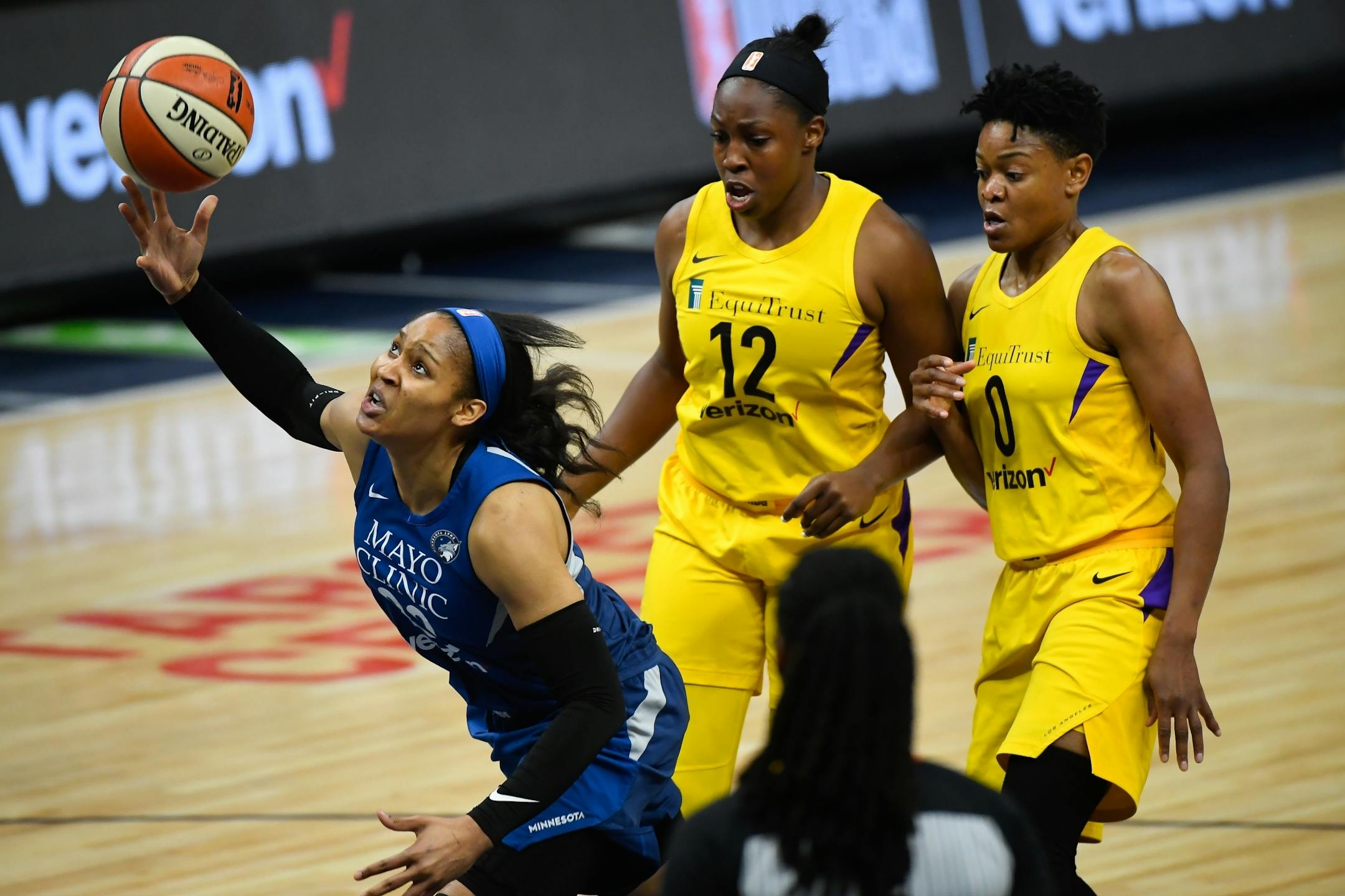Minnesota Lynx forward Maya Moore (23) was unable to make the layup as she was fouled by Los Angeles Sparks guard Chelsea Gray (12) on the way toward the basket in the first quarter.
