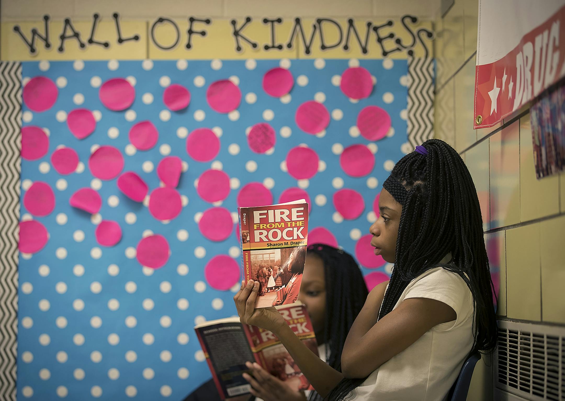 Students at Marcus Garvey Elementary School took time to read outside their classroom near the "Wall of Kindness," Tuesday, March 21, 2017 in Chicago, IL. The wall is meant to be used as a message board for students to write affirmations to others as part of the Social Emotional Learning (SEL) environment at the school.