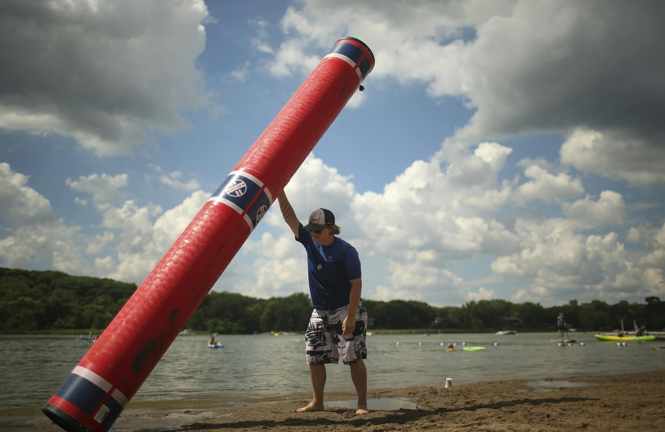 Three Rivers Park District outdoor educator Taylor Moore drained the water from the "log" used in the log rolling workshop before pulling it out of the lake Sunday afternoon at Fish Lake Regional Park. ] JEFF WHEELER &#xef; jeff.wheeler@startribune.com The Three Rivers Park District presented a Family Log Rolling workshop at Fish Lake Regional Park in Maple Grove Sunday afternoon, July 26, 2015. On what proved to be a perfect day for it, participants learned techniques for log rolling from outdo