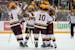 Gophers teammates celebrate with Mason Nevers (18) who scored with an assist from Jaxon Nelson (24), at left, in the second period Friday vs. Notre Da