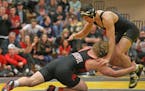 Shakopee wrestler Jack Casey at 182 lunges toward Apple Valley wrestler Tony Watts at 170 during the Minnesota State High School Section Championship 