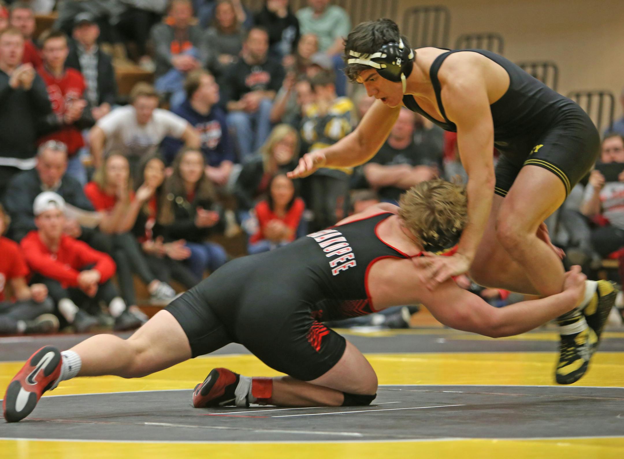 Shakopee wrestler Jack Casey at 182 lunges toward Apple Valley wrestler Tony Watts at 170 during the Minnesota State High School Section Championship on Friday, Feb. 16, 2018. Apple Valley lost to Shakopee.
