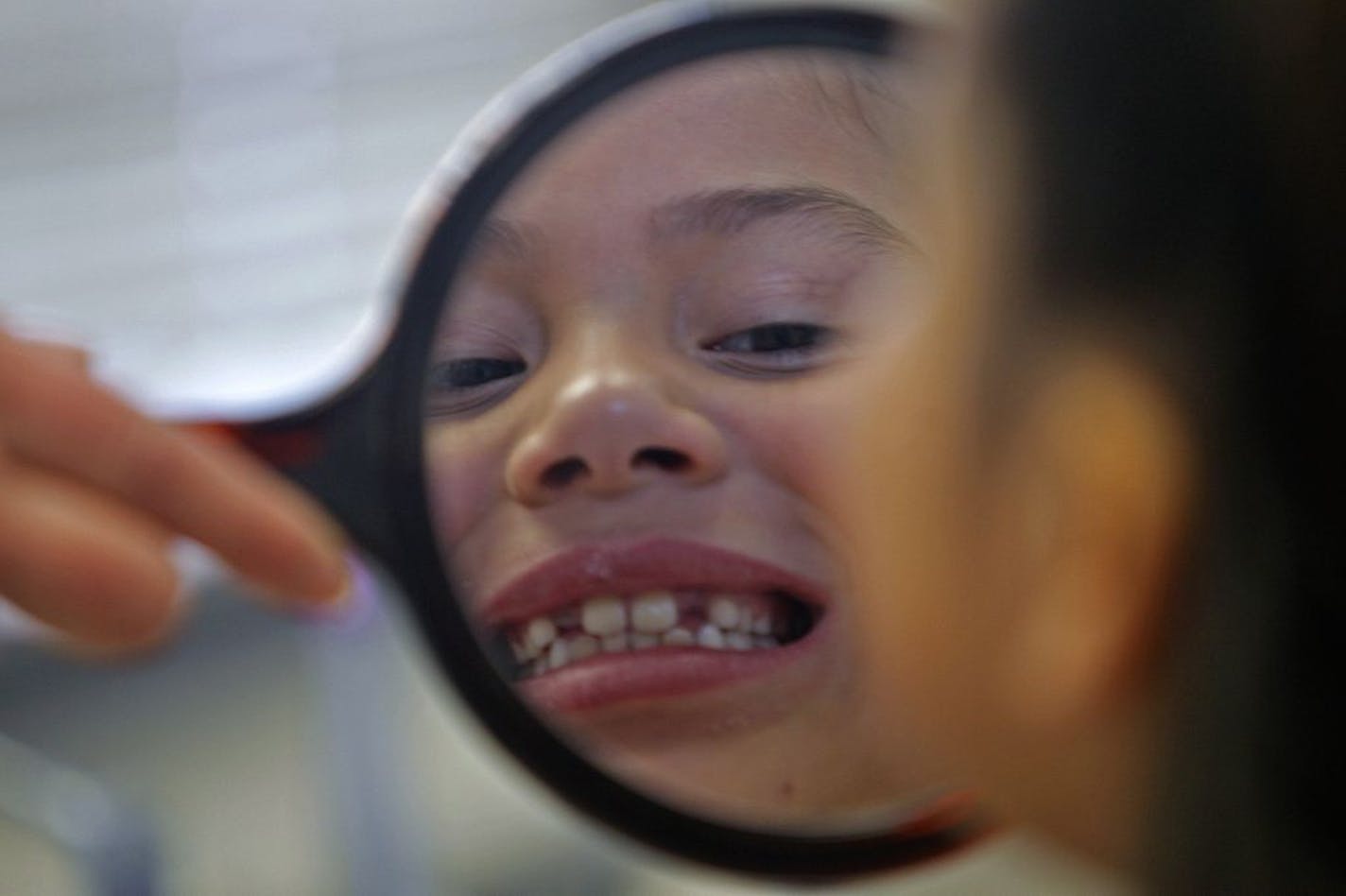 Zoe Medina, 7, took a brief look at her shiny white teeth after being cleaned at the Eden Prairie Park Dental office, Friday, February 1, 2013. Medina was one of 32 patients signed up to get free dental care. The entire Park Dental staff came in on a voluntary basis to work for Give Kids a Smile. The organization is a charitable program coordinated by the Minnesota Dental Association to provide free care to low-income children in need. The two-day, statewide event is Friday, Feb. 1, and Saturday