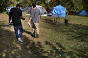 Brandon O'Neil Abrams, 31, left, and Brandon Harrison, 35, walked through Logan Park where they were both living in tents in October. Three encampment