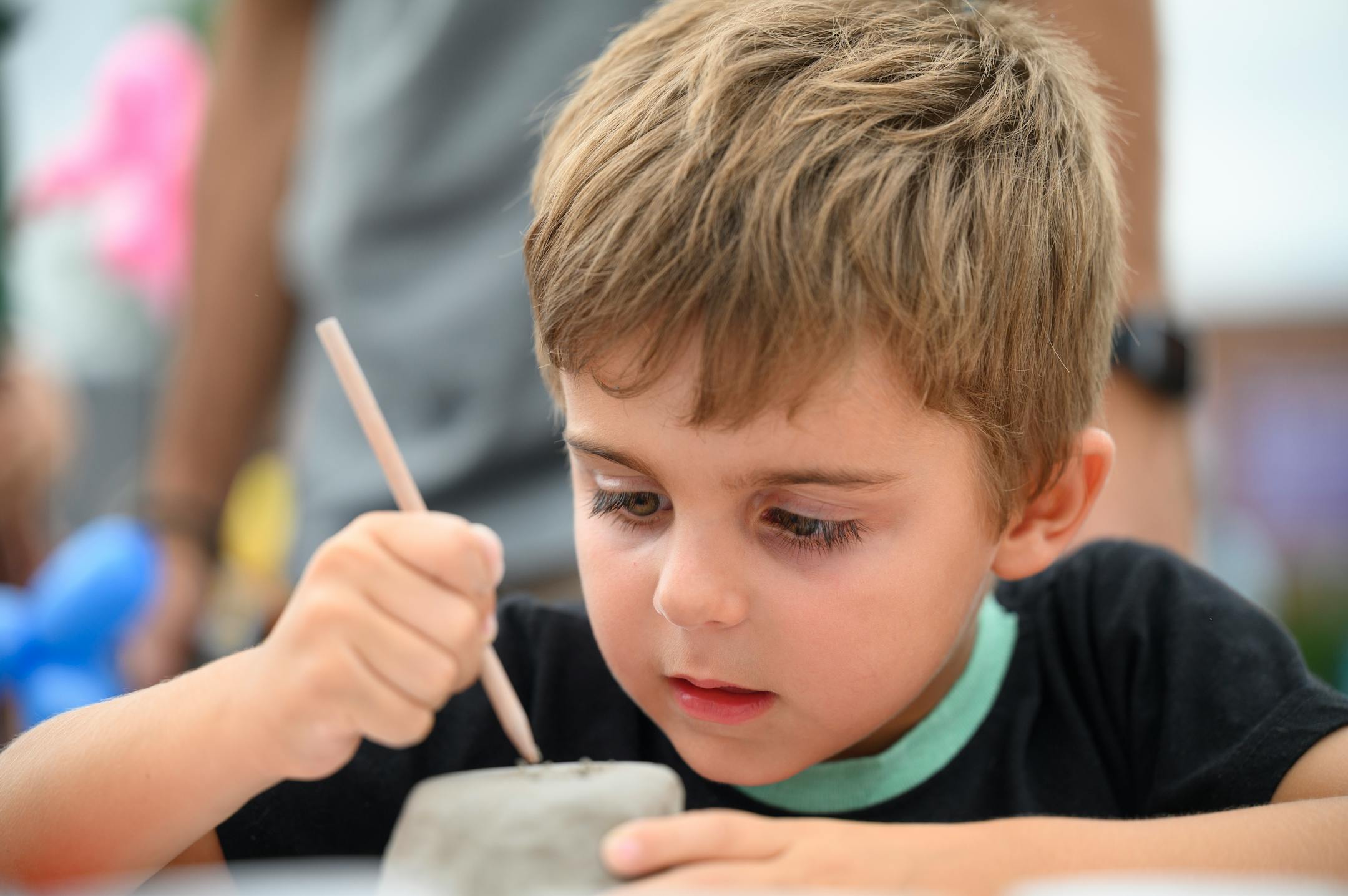 Rafael Alcaide Garcia, 5, works on a piece of pottery.