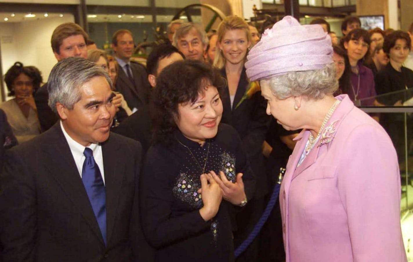 FILE - In this Tuesday, June 27, 2000 file photo, Britain's Queen Elizabeth II, right, opens the new Wellcome Wing of London 's Science Museum with Associated Press photographer Nick Ut, left and Phan Thi Kim Phuc, center. Phuc was the main subject in Ut's iconic image of the aftermath of a June 8, 1972 napalm attack in Vietnam. The image is featured in the museum.