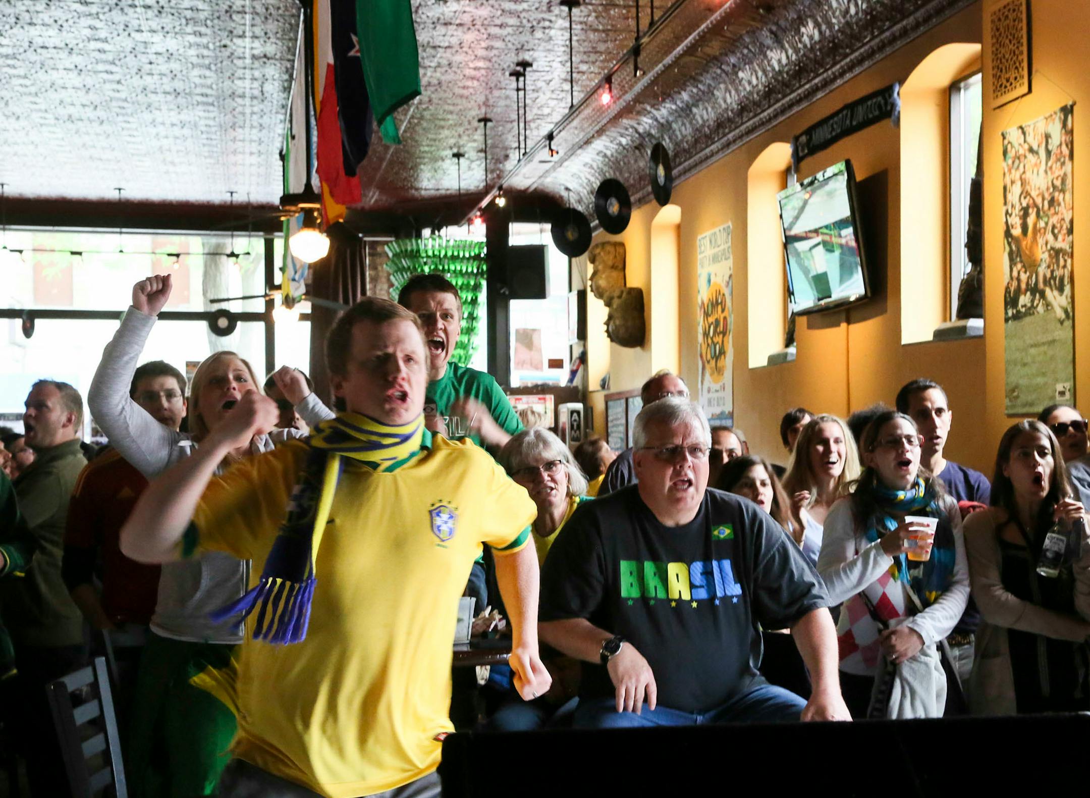 Members of the Bubna family of Brooklyn Center rode a wave of emotion at Nomad World Pub when Brazil opened the World Cup on June 12. The Bubnas, who lived in Brazil for 27 years, celebrate a goal by Brazil against Croatia.