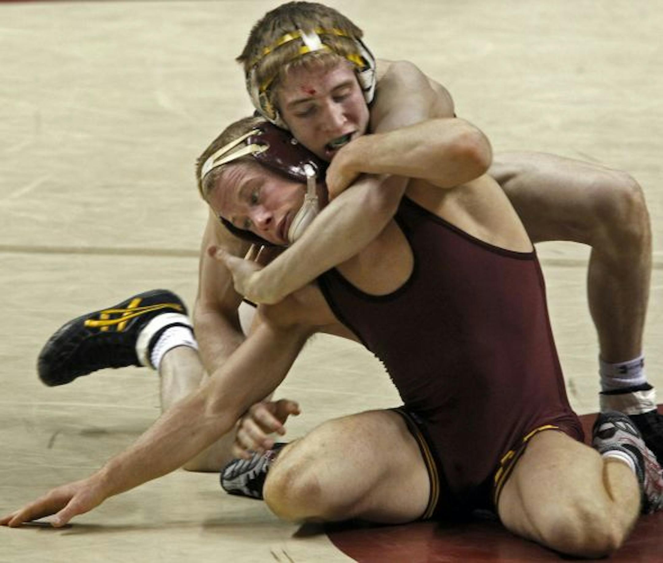 Iowa's Matt McDonough, top defeated Minnesota's Zach Sanders in the 125 lb match.