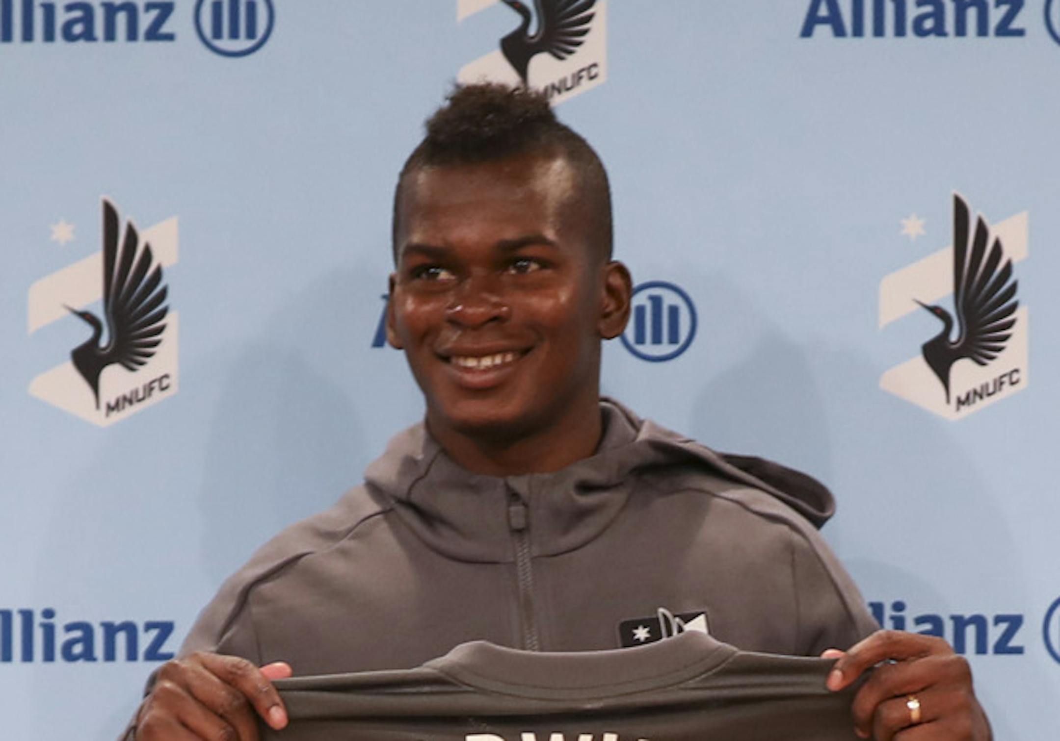 Darwin Quintero held up his new jersey after the news conference where he was introduced Monday afternoon. At right is team public relations manager Jessica Lopez. ] JEFF WHEELER • jeff.wheeler@startribune.com The Minnesota United Football Club introduced the team's first high-profile - and highly paid - designated player, Darwin Quintero, at a news conference in St. Paul Monday afternoon, April 2, 2018. ORG XMIT: MIN1804021520340169