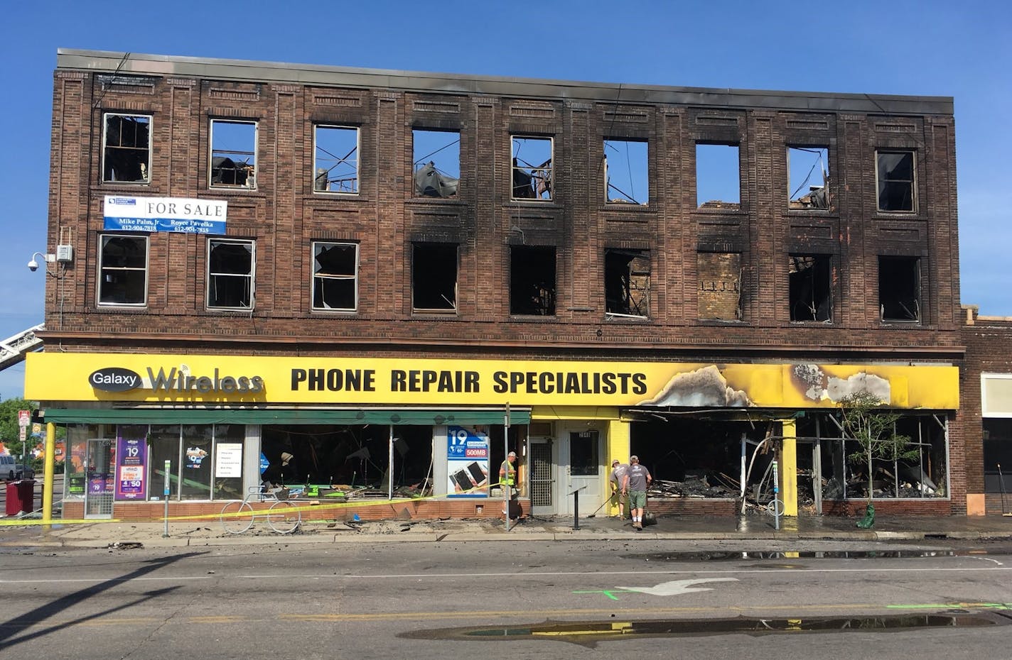 Crews are shoveling up glass and other debris outside the building at Chicago and Lake in Minneapolis that was gutted by fire overnight.