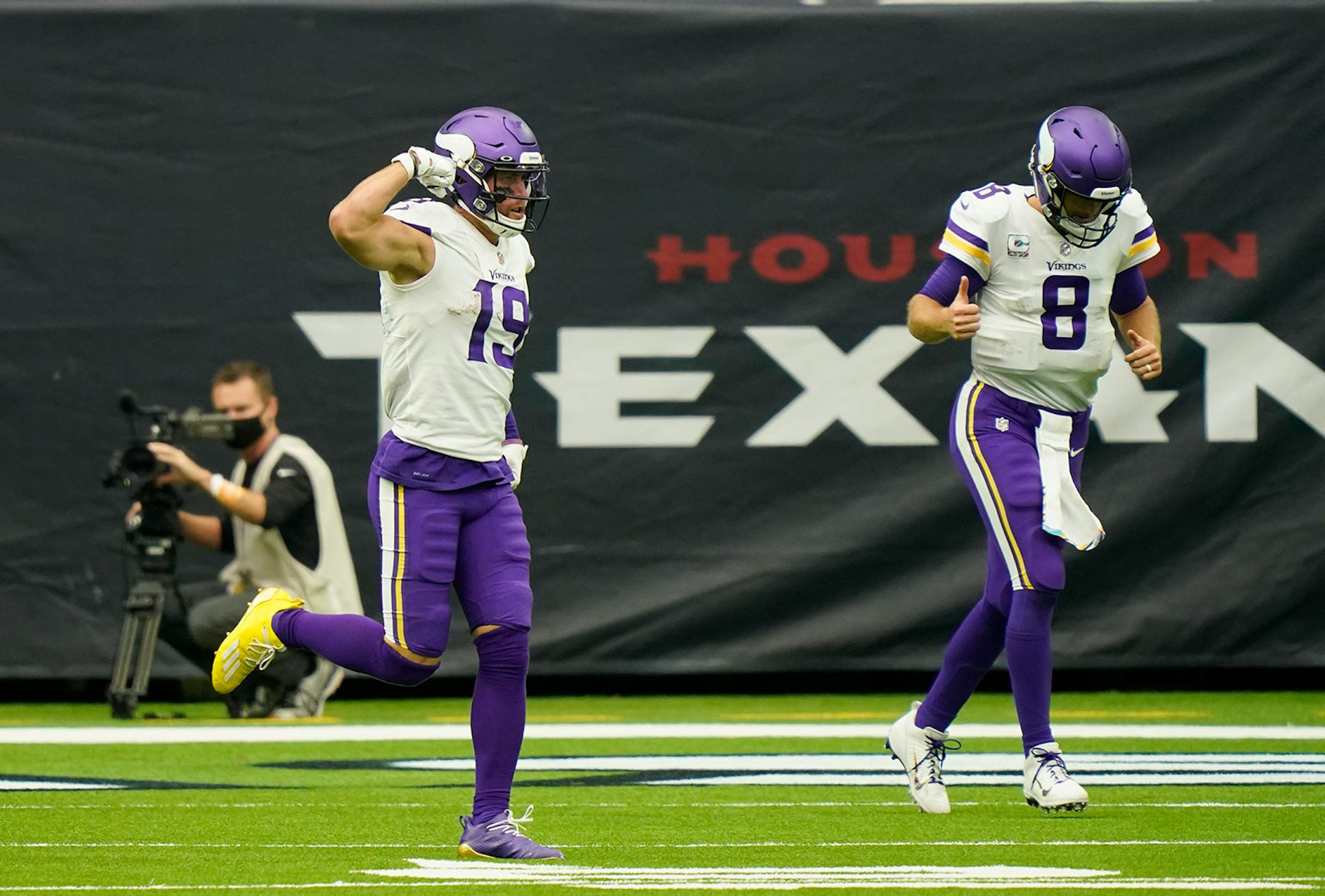 Minnesota Vikings wide receiver Adam Thielen (19) and quarterback Kirk Cousins (8) celebrates after they connected on a pass for a touchdown against the Houston Texans during the second half of an NFL football game Sunday, Oct. 4, 2020, in Houston. (AP Photo/David J. Phillip)