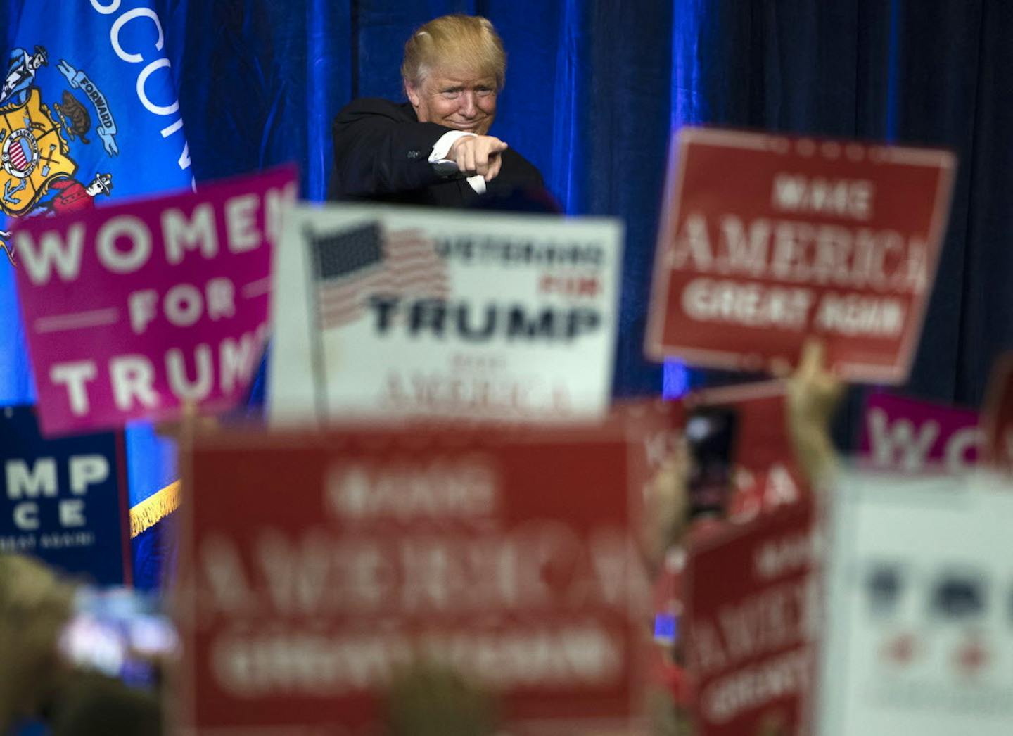 FILE - In this Tuesday, Nov. 1, 2016, Republican presidential candidate Donald Trump gestures during a campaign state at the University of Wisconsin-Eau Claire in Eau Claire, Wis. In his victory speech, Trump called them America&#xed;s &#xec;forgotten men and women&#xee;, the workers from the coalfields of Appalachia to the hallowing manufacturing towns of the Rust Belt who propelled him to an improbable victory. They felt left behind by progress, laughed at by the elite, and so put their faith