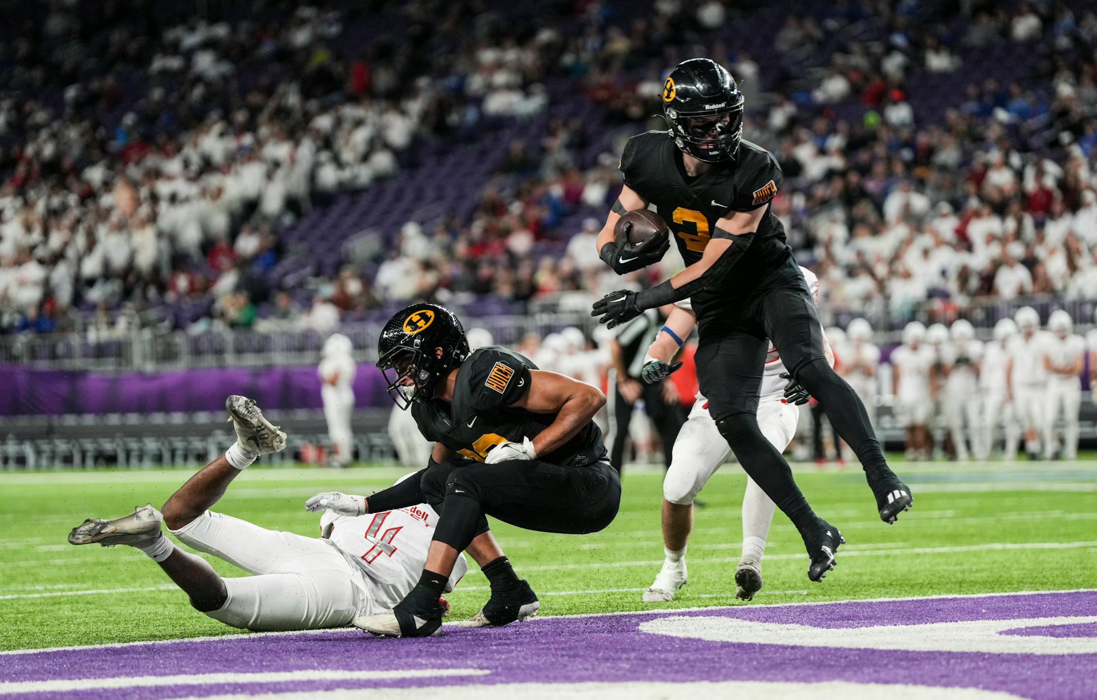 Hutchinson Tigers running back Levi Teetzel (2) leaps into the end zone for the extra points during the first half.