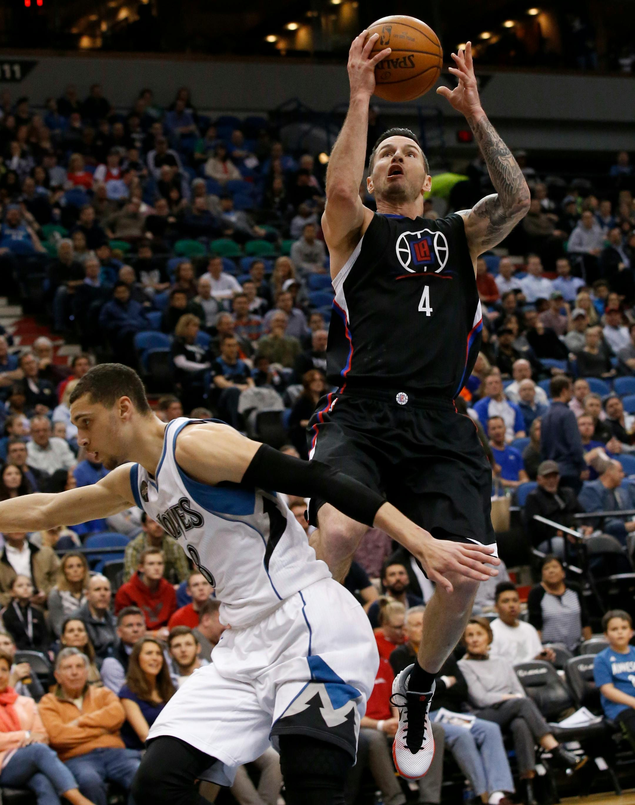 Los Angeles Clippers guard J.J. Redick (4) goes up for a shot over Minnesota Timberwolves guard Zach LaVine, left, during the second half of an NBA basketball game in Minneapolis, Wednesday, March 30, 2016. The Clippers won 99-79. (AP Photo/Ann Heisenfelt)