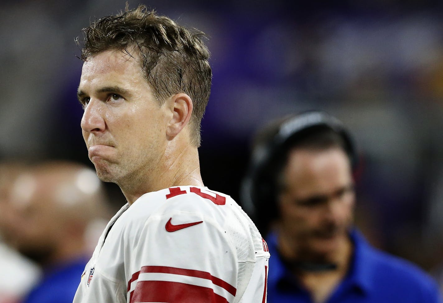 New York Giants quarterback Eli Manning watched form the sidelines late in the fourth quarter. Minnesota beat New York by a final score of 24-10.